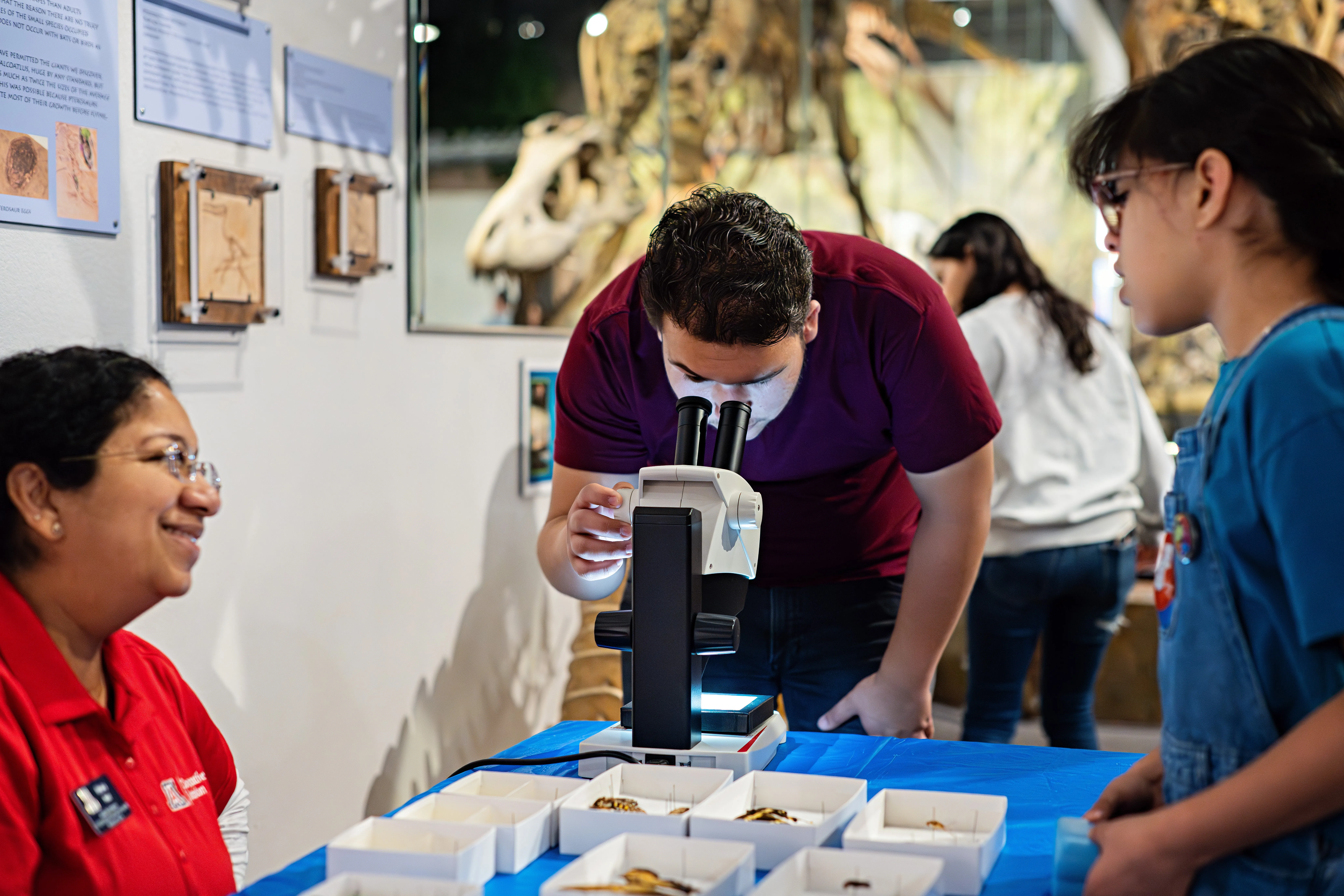 Two youth interacting with a science booth at the Arizona Museum of Natural History