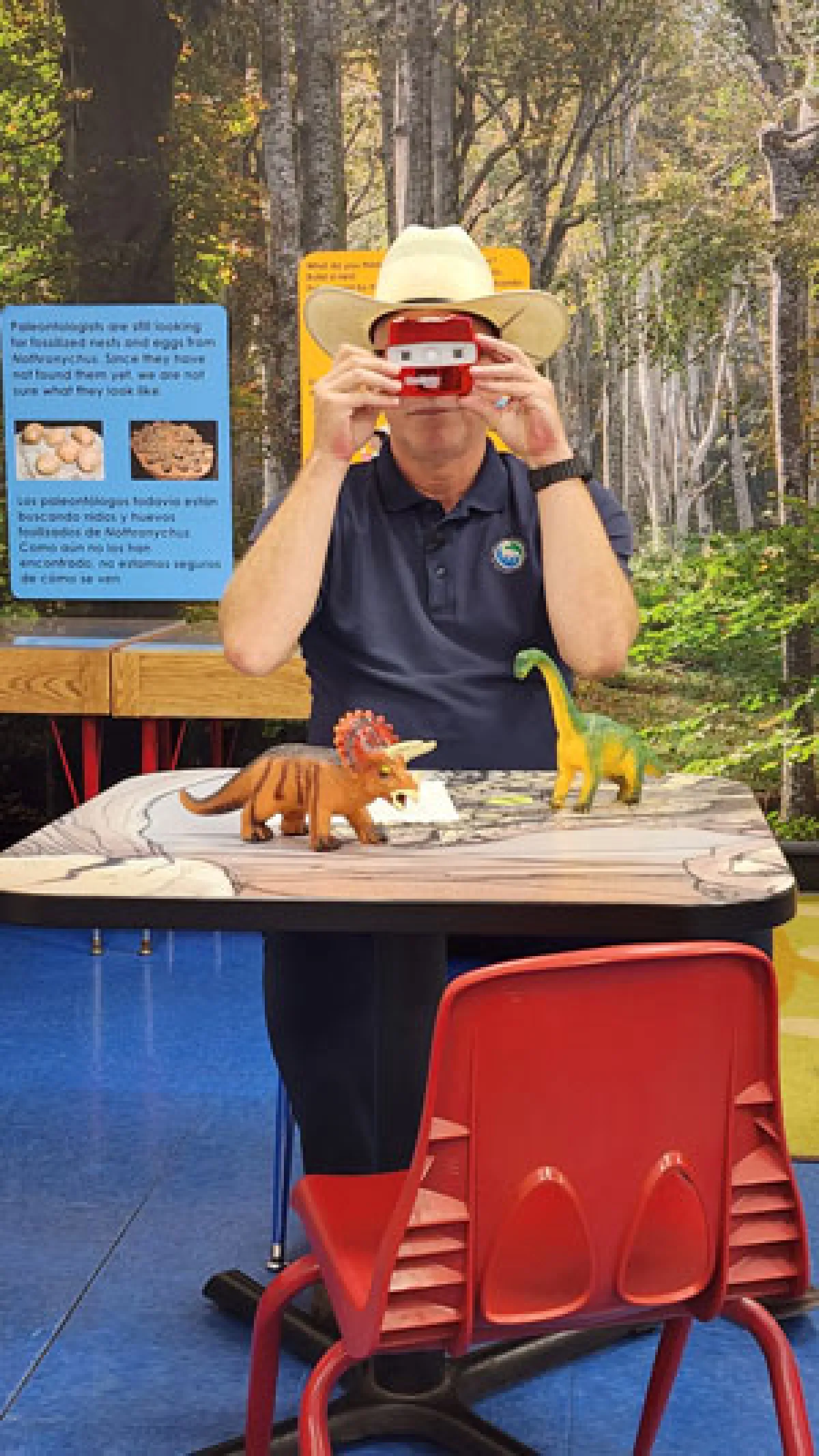 Simon sits looking through a red viewmaster